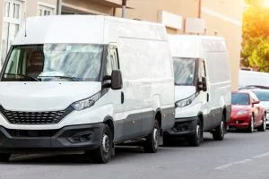Small,cargo,delivery,van,parked,in,european,city,central,district.